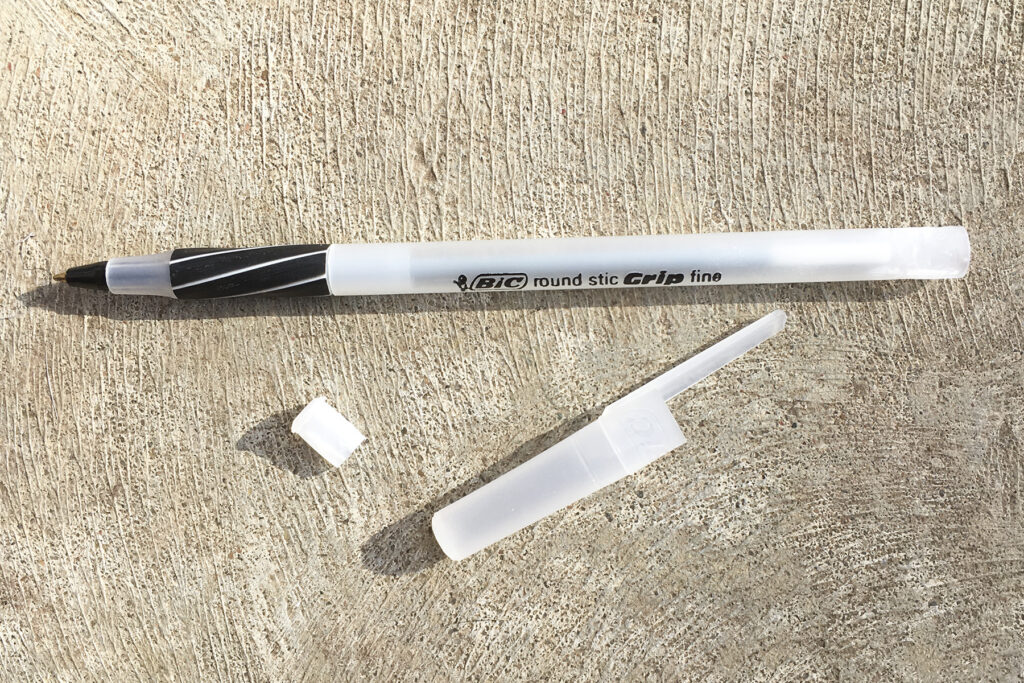 Remove both ends of a ball point pen