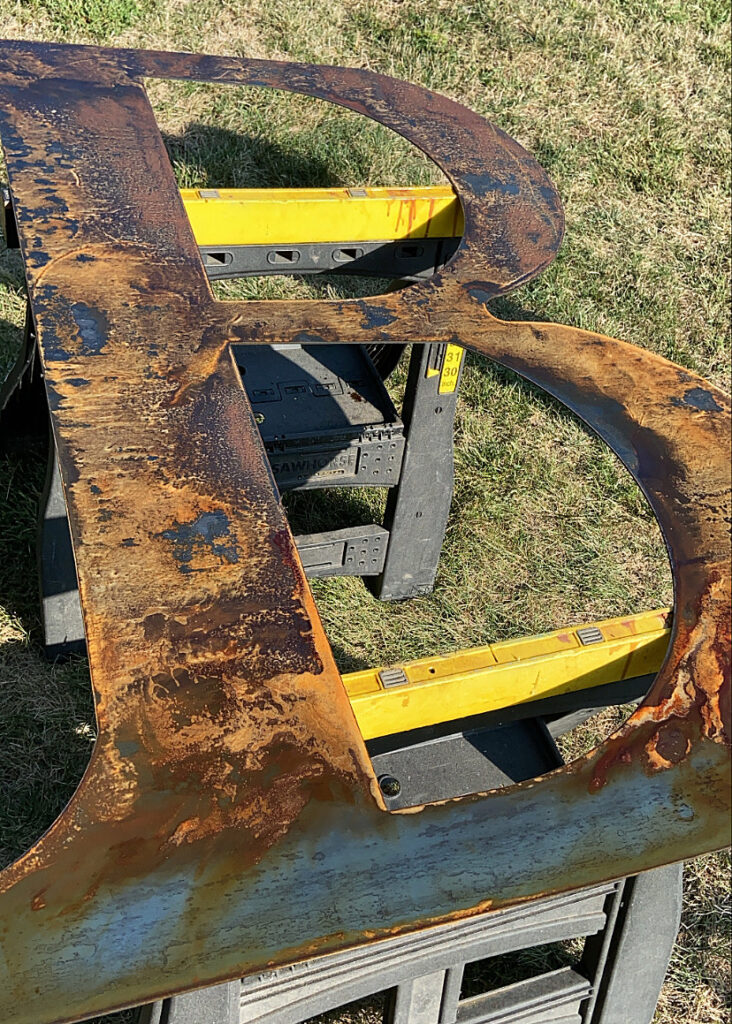 Rusted Metal Barn Letter Close-Up